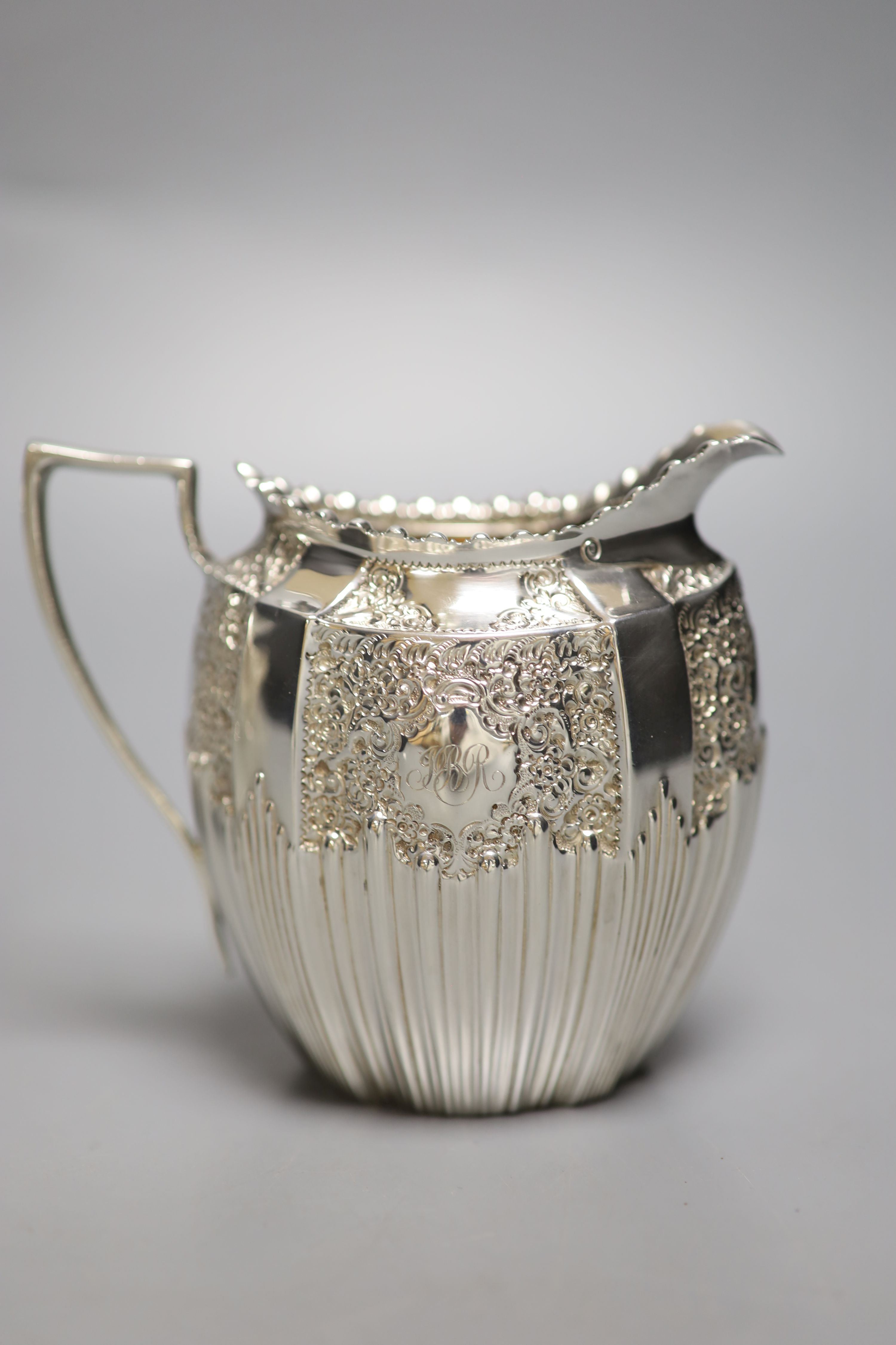 A late Victorian embossed silver sugar bowl and cream jug, James Dixon & Sons, Sheffield, 1896/7,